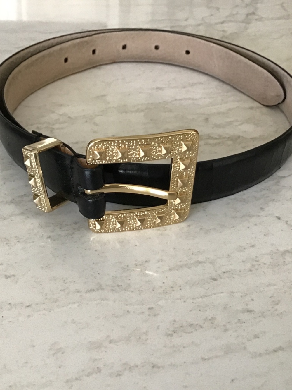 Black leather belt with gold textured buckle